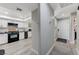Hallway view showcasing the kitchen with stainless steel appliances and a white front door at 450 Intrepid Ct, Boulder City, NV 89005
