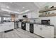 Modern kitchen featuring white cabinets, stainless steel appliances, and a farmhouse sink at 450 Intrepid Ct, Boulder City, NV 89005