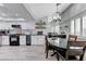 Open kitchen with white cabinets, stainless appliances, and an adjacent dining area at 450 Intrepid Ct, Boulder City, NV 89005
