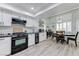 Kitchen with stainless steel appliances open to the dining area with large windows at 450 Intrepid Ct, Boulder City, NV 89005