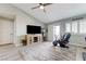 Relaxing living room area with ceiling fan, view to patio, and comfortable seating at 450 Intrepid Ct, Boulder City, NV 89005