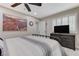 Bedroom with black metal bed frame, ceiling fan, and media center at 450 Intrepid Ct, Boulder City, NV 89005
