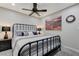Bedroom with black metal bed frame, ceiling fan, and neutral decor at 450 Intrepid Ct, Boulder City, NV 89005