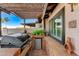 Built-in grill and beverage refrigerator are featured in this outdoor kitchen on the covered patio at 450 Intrepid Ct, Boulder City, NV 89005