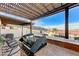 The outdoor kitchen has a built-in grill and bar seating on the home's covered patio at 450 Intrepid Ct, Boulder City, NV 89005