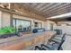 The outdoor kitchen offers a built-in bar and grill with a view from the covered patio of the home at 450 Intrepid Ct, Boulder City, NV 89005