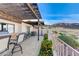 Wide shot of the covered patio with outdoor kitchen and seating overlooking the desert landscape and mountain views at 450 Intrepid Ct, Boulder City, NV 89005