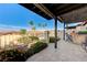 Inviting covered patio with outdoor seating area, perfect for enjoying the beautiful landscaping and mountain views at 450 Intrepid Ct, Boulder City, NV 89005