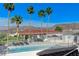 Gated community pool with lounge seating and palm trees at 450 Intrepid Ct, Boulder City, NV 89005