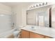 Bright bathroom featuring a single sink vanity, toilet, shower, and a large mirror at 4655 Gold Dust Ave # 210, Las Vegas, NV 89120