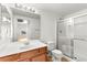 Bright bathroom featuring a single sink vanity, toilet, and enclosed shower at 4655 Gold Dust Ave # 210, Las Vegas, NV 89120
