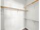 Clean, walk-in closet with wooden rails and white shelving for organization at 4655 Gold Dust Ave # 210, Las Vegas, NV 89120