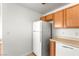 This kitchen features a white refrigerator, wood cabinets, and a white dishwasher at 4655 Gold Dust Ave # 210, Las Vegas, NV 89120