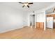 Bright living room with wood floors leading to an open kitchen and hallway at 4655 Gold Dust Ave # 210, Las Vegas, NV 89120