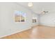 Bright living room with wood-look floors, ceiling fan, and ample sunlight from the window at 4655 Gold Dust Ave # 210, Las Vegas, NV 89120