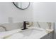 Close-up of a bathroom featuring marble countertops and black faucet at 517 N 22Nd St, Las Vegas, NV 89101