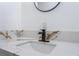 Close-up of bathroom vanity with white cabinets, quartz countertop, and matte black faucet at 517 N 22Nd St, Las Vegas, NV 89101