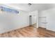 Bedroom featuring hardwood floors, white walls, and a closet with sliding mirrored doors, offering ample storage space at 517 N 22Nd St, Las Vegas, NV 89101