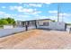 Single-story home with gravel landscaping and a driveway, and secure gate at 517 N 22Nd St, Las Vegas, NV 89101