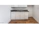 This kitchen features bright white cabinets and laminate counters at 517 N 22Nd St, Las Vegas, NV 89101