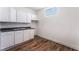 Clean kitchen with white cabinets, a stainless steel sink, and a window offering natural light at 517 N 22Nd St, Las Vegas, NV 89101