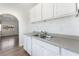 Bright kitchen boasts stainless steel sink, white cabinetry and arched doorway for an open feel at 517 N 22Nd St, Las Vegas, NV 89101