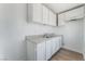 Bright kitchen features white cabinetry, double sink, and ample counter space for easy meal preparation at 517 N 22Nd St, Las Vegas, NV 89101