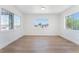 Bright living room featuring wood floors, white walls and ample natural light through the windows at 517 N 22Nd St, Las Vegas, NV 89101