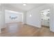 Bright living room area leading to a bathroom with modern fixtures and hardwood floors at 517 N 22Nd St, Las Vegas, NV 89101