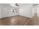 Bright living room featuring wood-look flooring, a ceiling fan, and ample natural light at 517 N 22Nd St, Las Vegas, NV 89101