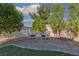Backyard sitting area with a bistro table and two chairs with blue cushions at 5229 Giallo Vista Ct, North Las Vegas, NV 89031