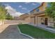 Backyard featuring a small lawn, desert landscaping, and a patio with a grill at 5229 Giallo Vista Ct, North Las Vegas, NV 89031