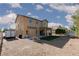 Expansive backyard with gravel, small grass patch, a trailer, and covered patio, ideal for outdoor gatherings at 5229 Giallo Vista Ct, North Las Vegas, NV 89031
