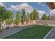 Backyard features a small lawn, desert landscaping, and a sitting area at 5229 Giallo Vista Ct, North Las Vegas, NV 89031