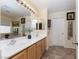 Spacious bathroom vanity with double sinks, a large mirror, and tile floors at 5229 Giallo Vista Ct, North Las Vegas, NV 89031