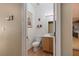 Half bath featuring a wood floor and vanity with framed art and decor at 5229 Giallo Vista Ct, North Las Vegas, NV 89031