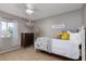 Bedroom features a ceiling fan and light fixture with a bed, dresser, and window at 5229 Giallo Vista Ct, North Las Vegas, NV 89031