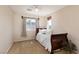 Bedroom with large window, wood bed frame, carpet, and white bedding at 5229 Giallo Vista Ct, North Las Vegas, NV 89031