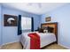 Bedroom with blue walls, ceiling fan, carpet, and a bright window at 5229 Giallo Vista Ct, North Las Vegas, NV 89031