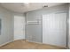 Bedroom featuring carpet floors, closet with double doors, and entry door at 5229 Giallo Vista Ct, North Las Vegas, NV 89031