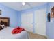Bedroom with blue walls, ceiling fan, carpet, and closet with sliding doors at 5229 Giallo Vista Ct, North Las Vegas, NV 89031