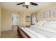 Bright bedroom with a ceiling fan, decorated bed, and a doorway to another room at 5229 Giallo Vista Ct, North Las Vegas, NV 89031