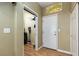 Hallway leading to the laundry closet with storage and decorated with vintage lemonade sign at 5229 Giallo Vista Ct, North Las Vegas, NV 89031