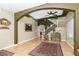 Open-concept living room showcasing hardwood flooring, archway, and direct access to stairs at 5229 Giallo Vista Ct, North Las Vegas, NV 89031