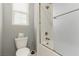 Bathroom featuring a shower-tub combination with white fixtures and a toilet at 5616 Silver Cascade Ave, Las Vegas, NV 89131