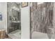 Modern bathroom featuring dual walk-in showers with grey tile and white tile floors at 5616 Silver Cascade Ave, Las Vegas, NV 89131