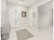 Bright foyer with white tile flooring, textured accent wall, and neutral decor creating an inviting entrance at 5616 Silver Cascade Ave, Las Vegas, NV 89131