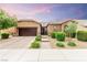 Charming single-story home featuring a well-manicured front yard and a two-car garage at 5616 Silver Cascade Ave, Las Vegas, NV 89131
