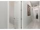 Bright hallway featuring neutral paint, wood-look floors, and elegant decor at 5616 Silver Cascade Ave, Las Vegas, NV 89131