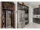 Modern kitchen with stainless steel appliances, wine storage, and ample storage space in dark wood cabinetry at 5616 Silver Cascade Ave, Las Vegas, NV 89131